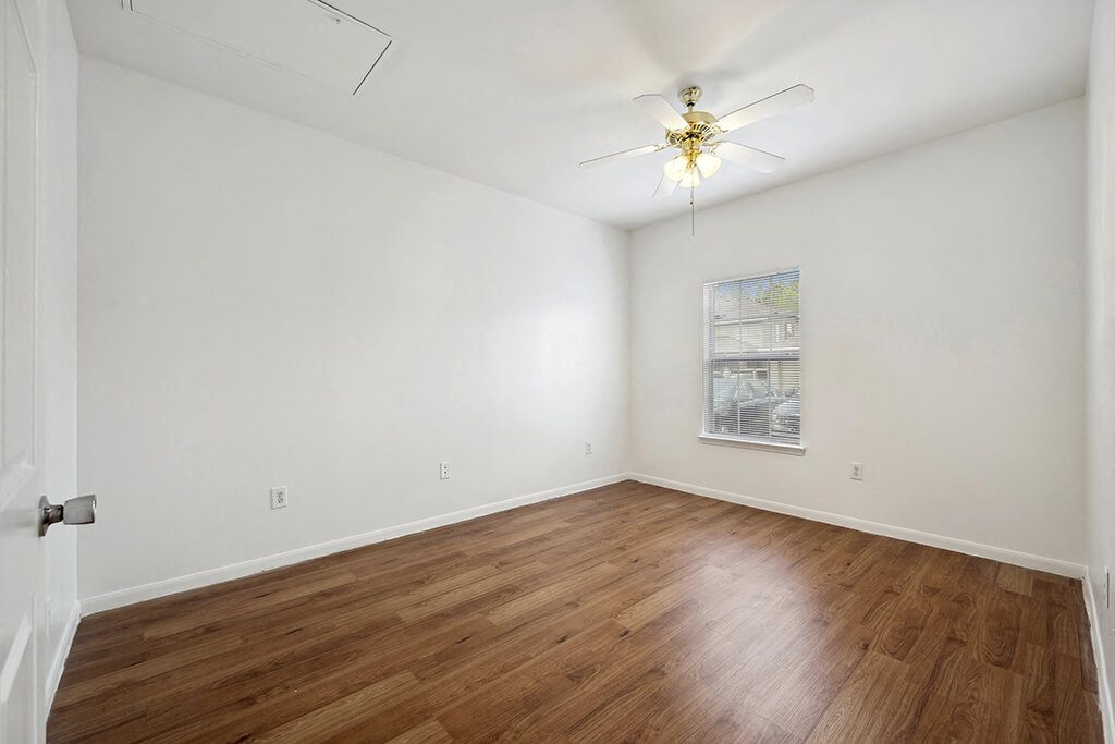 Bedroom with hardwood flooring at Fountains at Tidwell and The Enclave in Houston TX